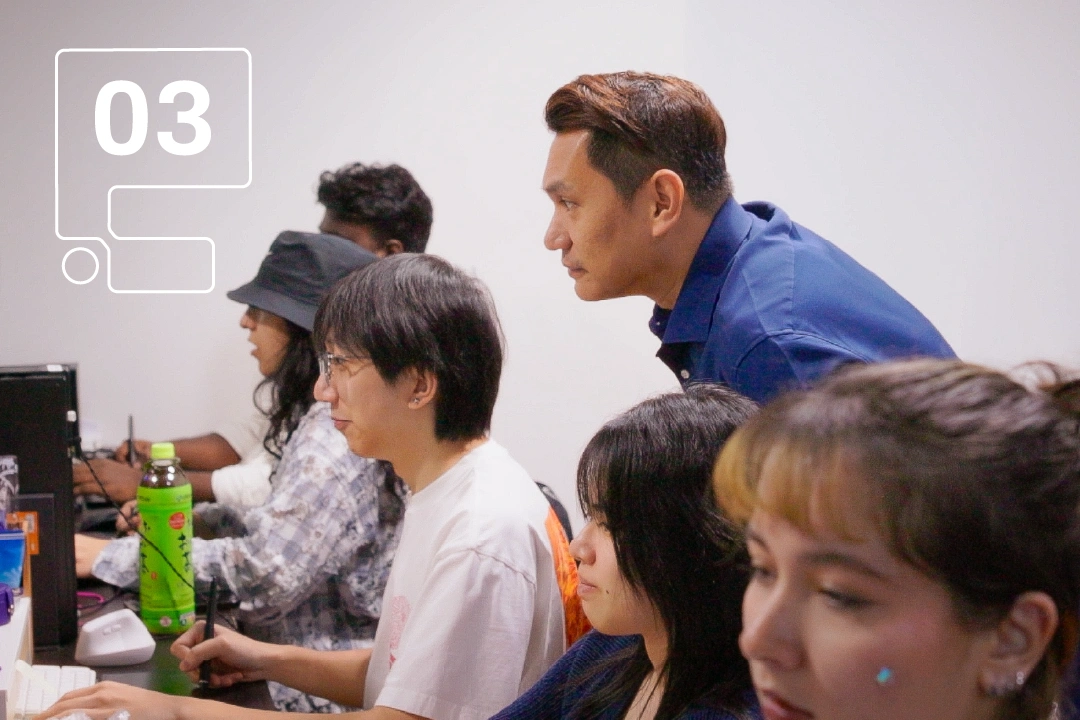 A group students engaged in classroom, with the lecturer actively observing and providing feedback on their work.