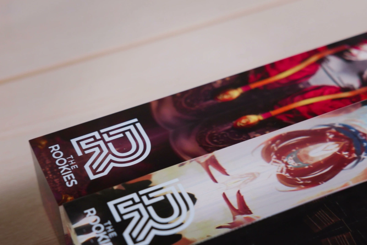 A close-up of printed annuals from The Rookies stacked on a desk.