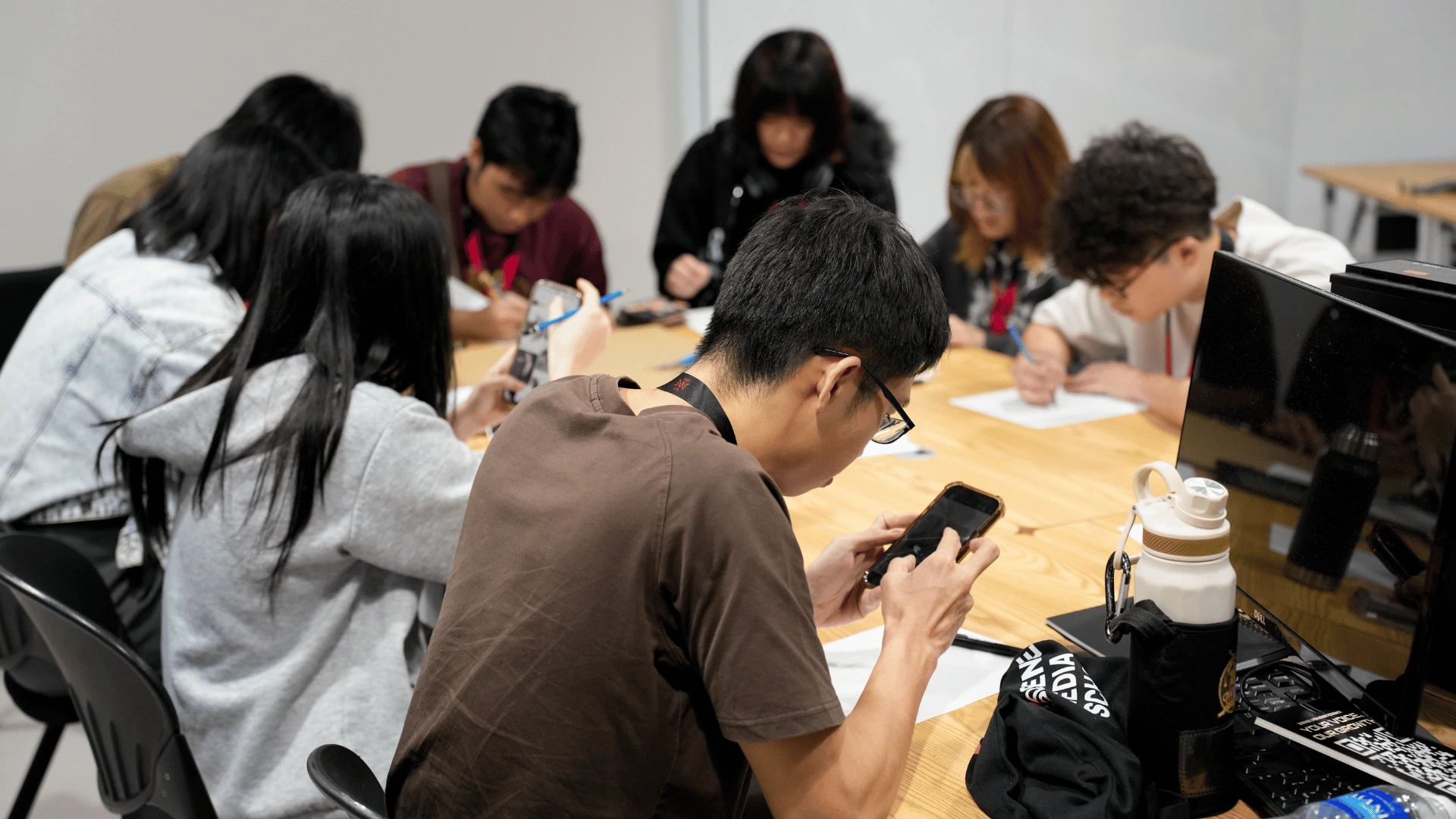 Students gathered at studio workstations during a hands-on Summit Day 2026 workshop, watching a digital art demonstration on screen