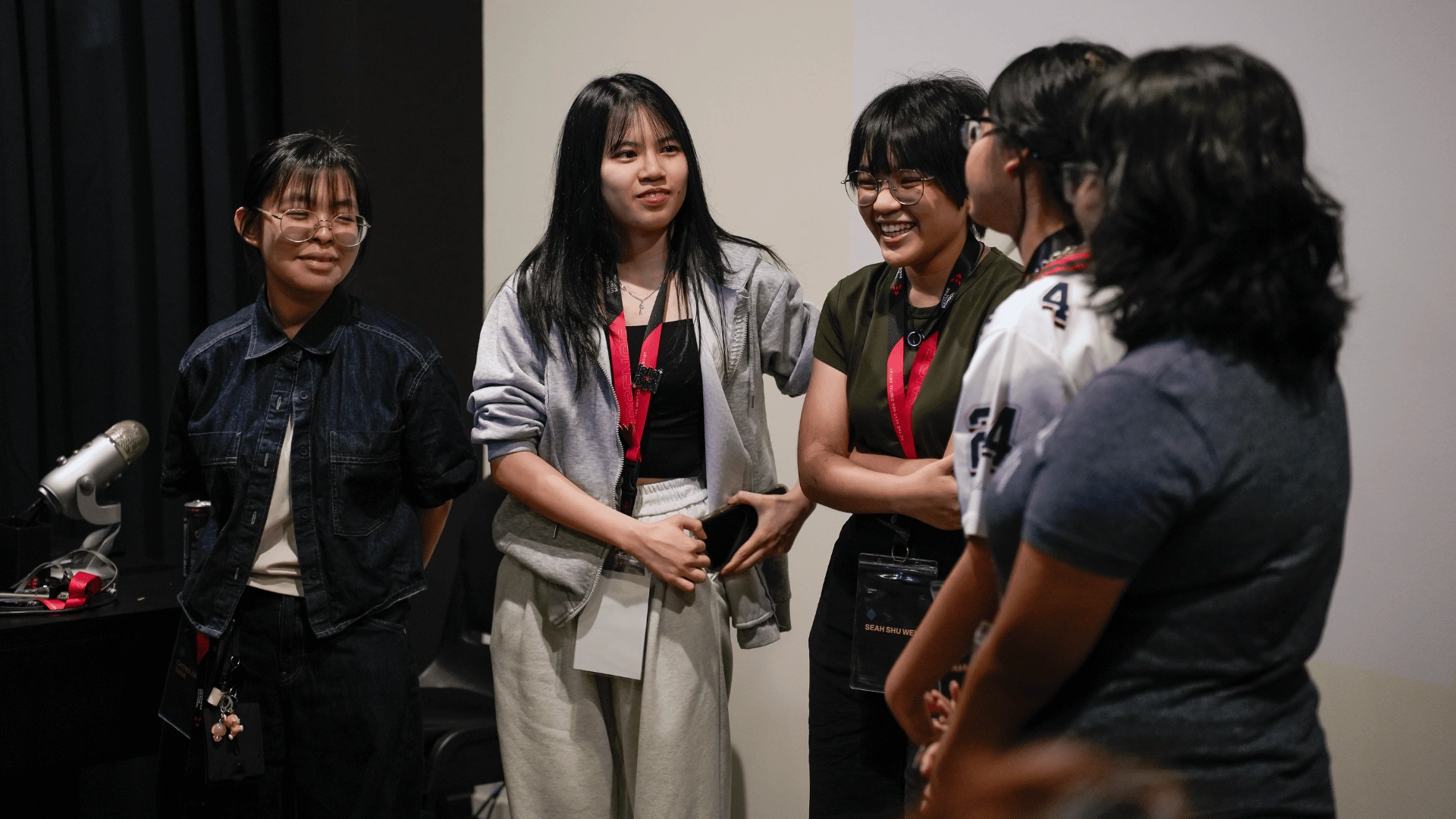 Participants introducing themselves during the Summit Day 2026 icebreaker, with the name-role-and-hobby game instructions projected on the screen behind them